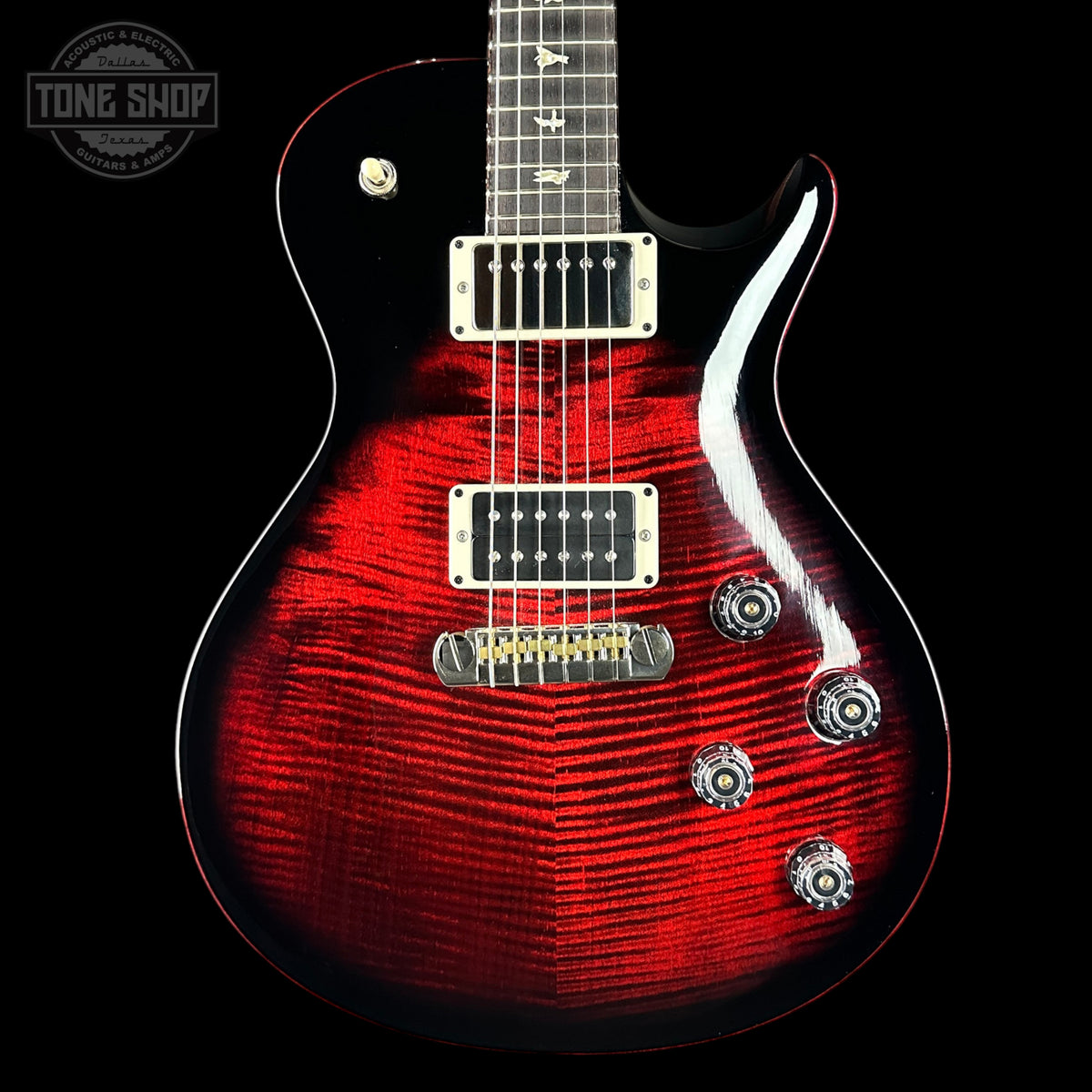 Red electric guitar with a black background