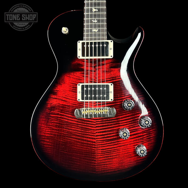 Red electric guitar with a black background