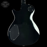 Black electric guitar body with visible brand logo on a black background