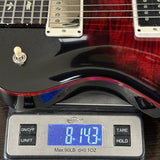 Electric guitar on a digital scale displaying weight