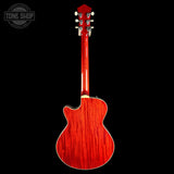 A glossy red electric guitar shown from the back, featuring a cutaway body and headstock, set against a solid black background with a Tone Shop watermark in the top left corner.