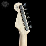 Guitar headstock with tuning pegs on a black background, featuring the 'Tone Shop' logo.