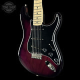 Electric guitar with a maroon finish on a black background, featuring the Tone Shop logo.