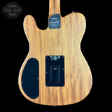 The back of a Fender Telecaster electric guitar, showing the natural wood backplate, black pickguard, and control plate, set against a solid black background.