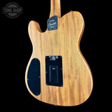 The back of a Fender Telecaster electric guitar with a natural wood grain finish, shown against a solid black background. Features a black pickguard, control plate, and a Tone Shop watermark in the top left corner.