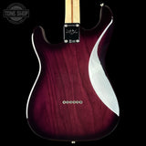 Guitar with a maroon body and white pickguard on a black background, featuring the Tone Shop logo.