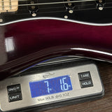 Guitar on a digital scale displaying weight
