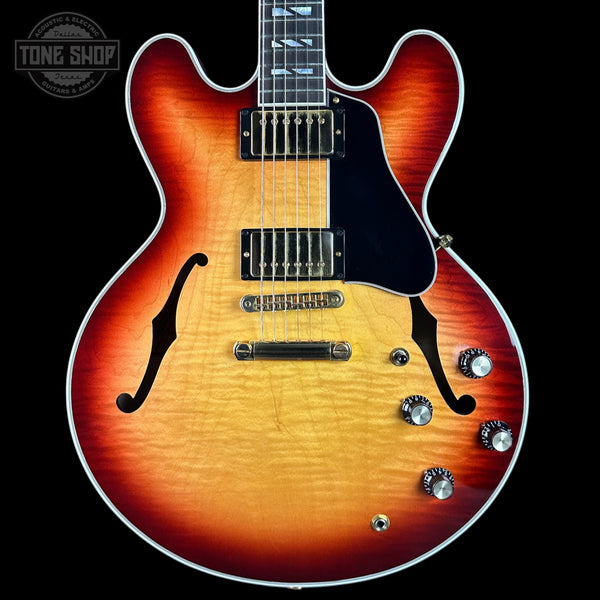 Electric guitar with a sunburst finish on a black background, featuring the Tone Shop logo.