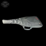 A gray padded guitar or bass gig bag with a top zippered pocket and red logo, shown against a solid black background. A Tone Shop watermark is visible in the top-left corner.