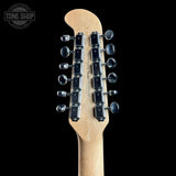 Close-up of the back of a light natural wood guitar headstock with dual rows of six silver tuning pegs against a solid black background. A Tone Shop watermark is visible in the top left corner.