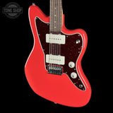 A red electric guitar with a glossy red body, dark red glitter pickguard, and white humbucker pickups, shown against a solid black background with a Tone Shop watermark in the top left corner.