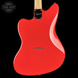 The rear view of a red electric guitar body with a maple neck and a black background, featuring a Tone Shop watermark in the top left corner.