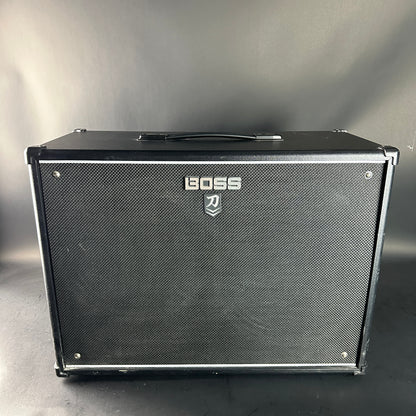 Black guitar amplifier with Boss logo on a gray background