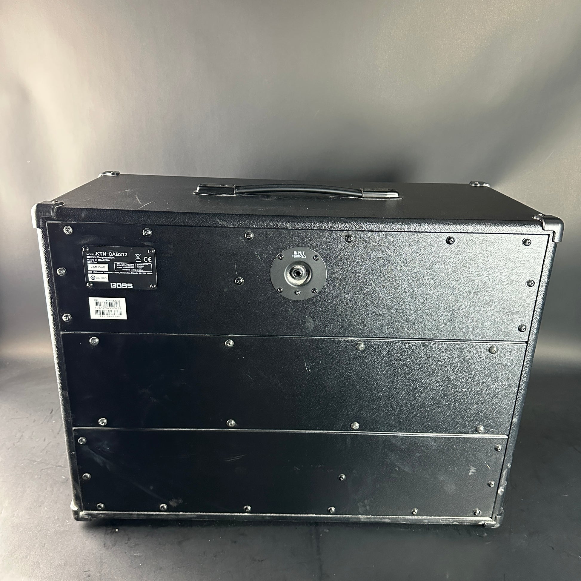 Black rectangular metal case with visible branding on a gray background