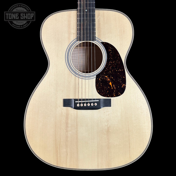 Acoustic guitar with a visible brand logo in the corner