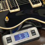 Used 2024 Gibson Les Paul Classic Ebony on scale displaying weight.