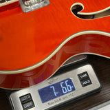 Used 2021 Gretsch G5427T on scale displaying weight.