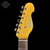 Close-up of a guitar headstock with 'K-Line' branding on a black background