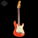 Red electric guitar with a white pickguard on a black background, featuring 'Tone Shop' logo.