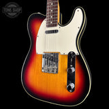 A classic Fender Telecaster electric guitar with a sunburst finish, cream pickguard, and black control plate, shown against a solid black background with a Tone Shop watermark in the top left corner.