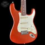 Red electric guitar with a white pickguard on a black background, featuring the Tone Shop logo.
