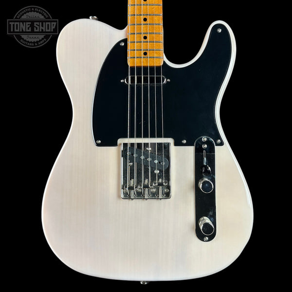 White electric guitar with a black pickguard on a black background, featuring 'Tone Shop' branding.