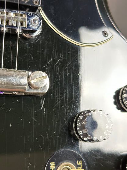 Close-up of a guitar's control knobs and headstock