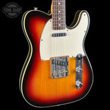 A classic Fender Telecaster electric guitar with a sunburst finish, cream pickguard, and chrome hardware, shown against a solid black background with a Tone Shop watermark in the top left corner.
