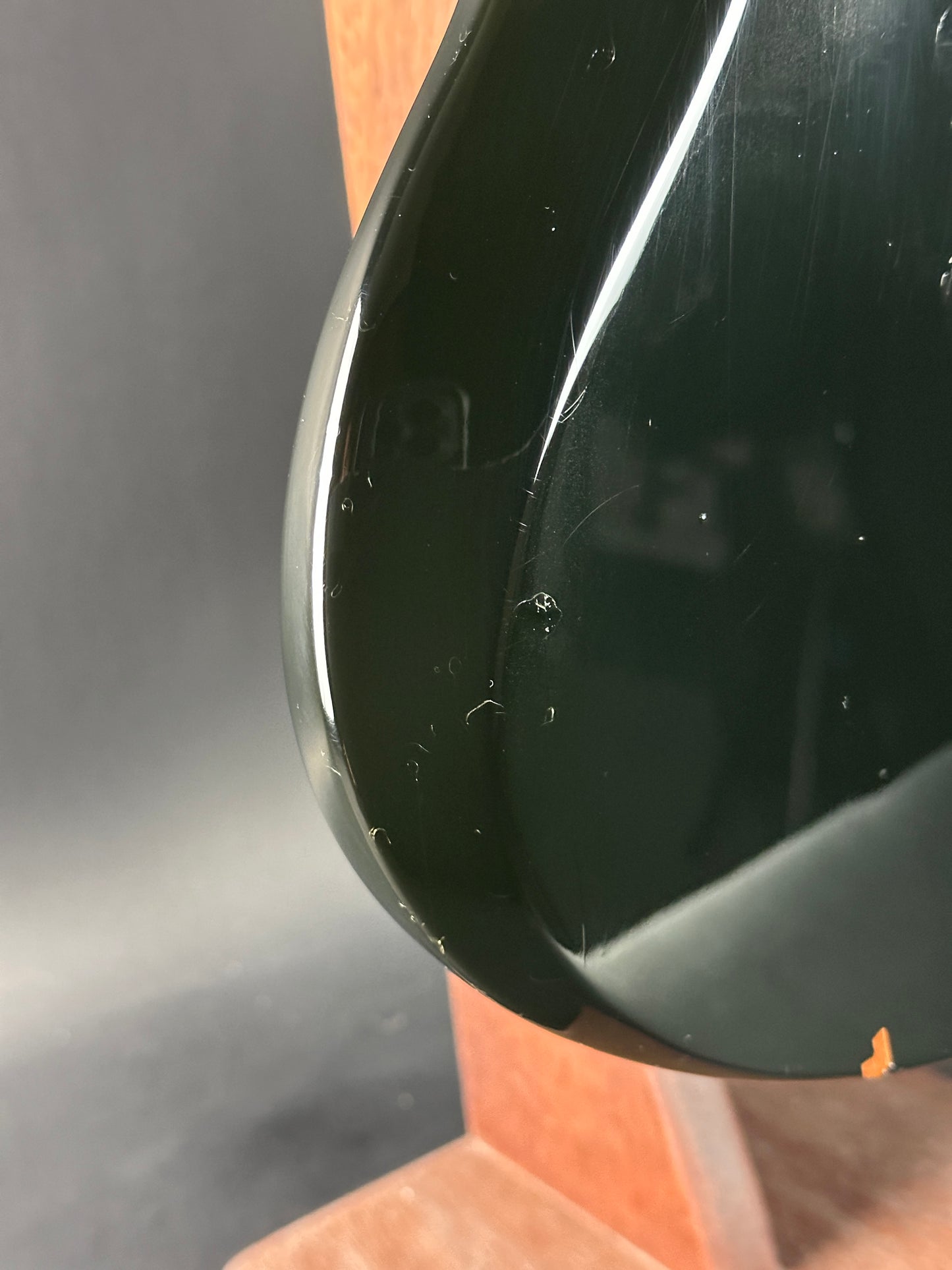 Close-up of a black object with a reflective surface on a gray background