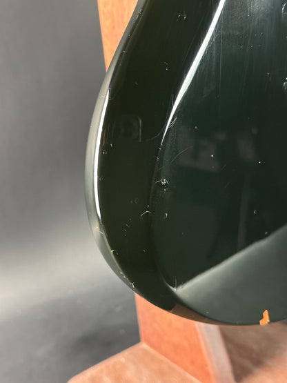 Close-up of a black object with a reflective surface on a gray background