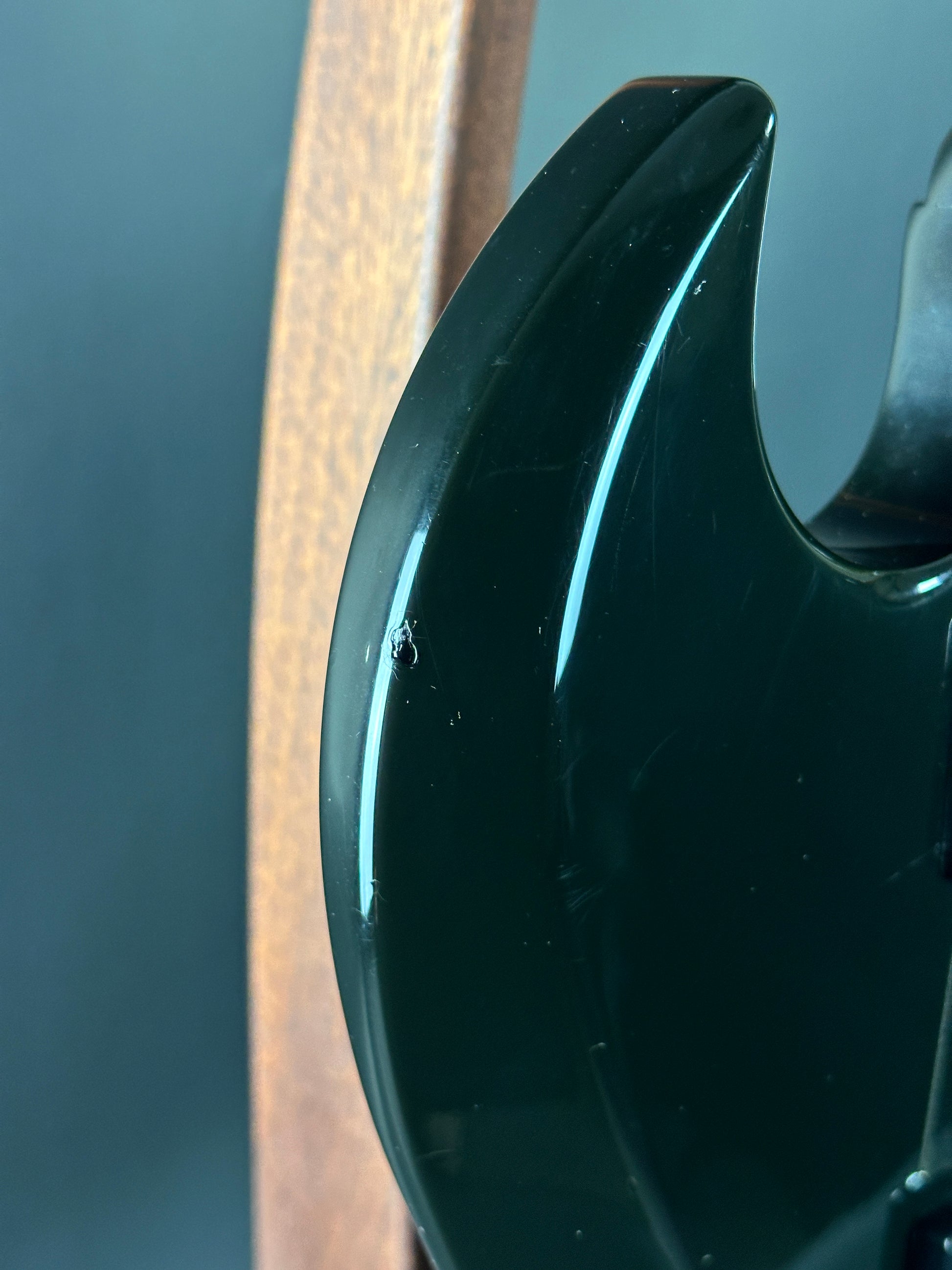 Close-up of a black plastic component on a metallic surface