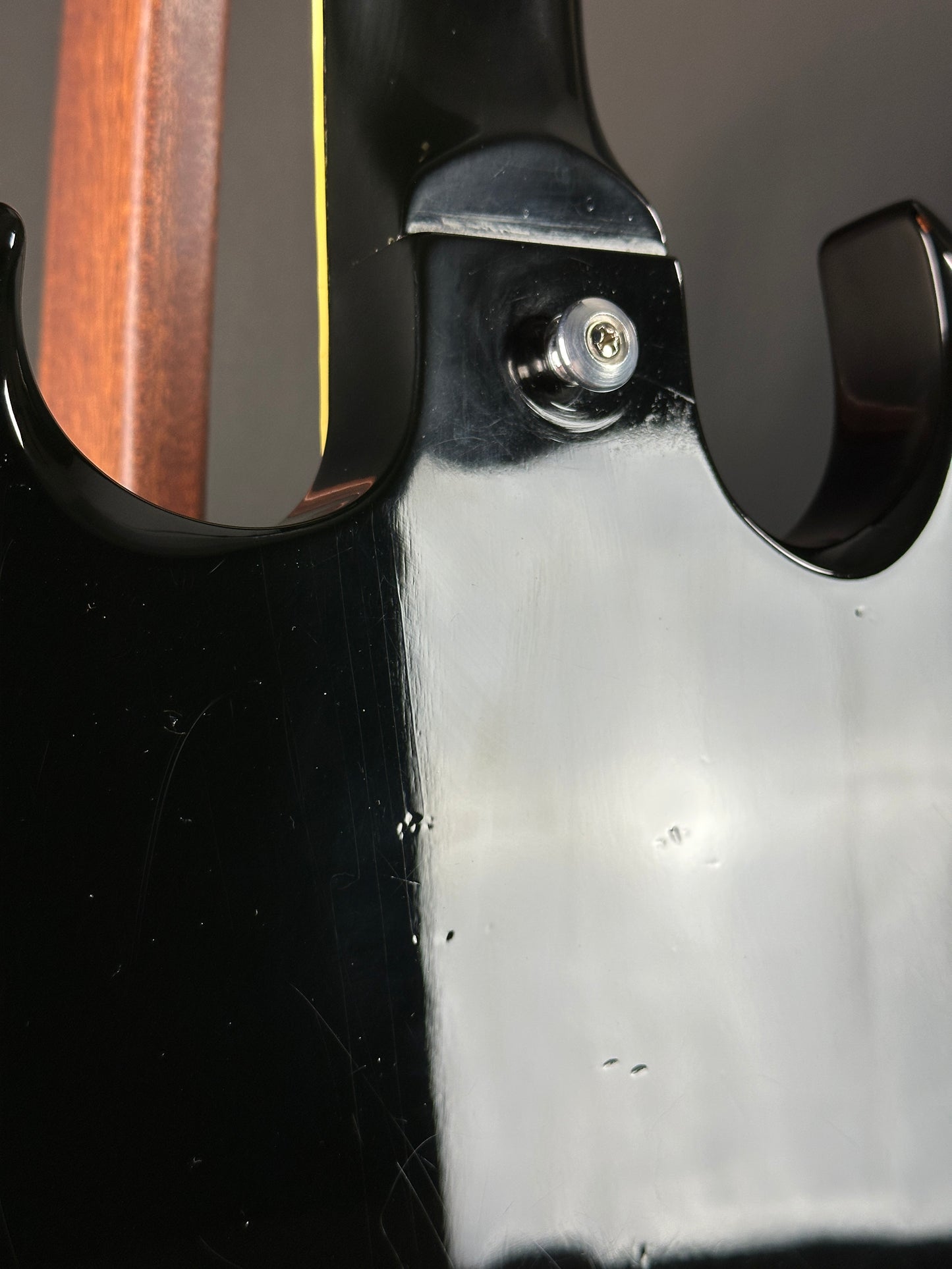 Close-up of a guitar's headstock with tuning pegs.