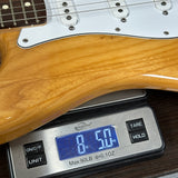 Used 2007 Fender Standard Stratocaster Natural Ash on scale displaying weight.