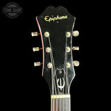 Epiphone guitar headstock on a black background