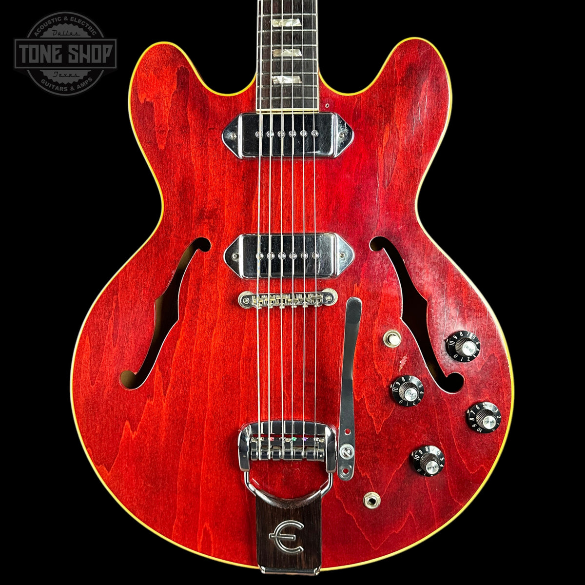 Red electric guitar with a black background