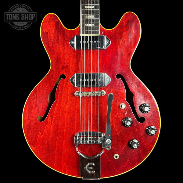 Red electric guitar with a black background