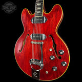 Red electric guitar with a black background