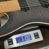 Used Schecter Sunset 24-7 USA Custom Shop Trans Black Pearl on scale displaying weight.