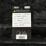 A black and white authenticity tag for a Taomei Stratocaster guitar headstock, placed on a black faux fur background. The tag features thePRS Guitar Center logo, a handwritten inventory list, and a signature at the bottom.