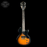 Electric guitar with a sunburst finish on a black background, featuring the Gibson logo.