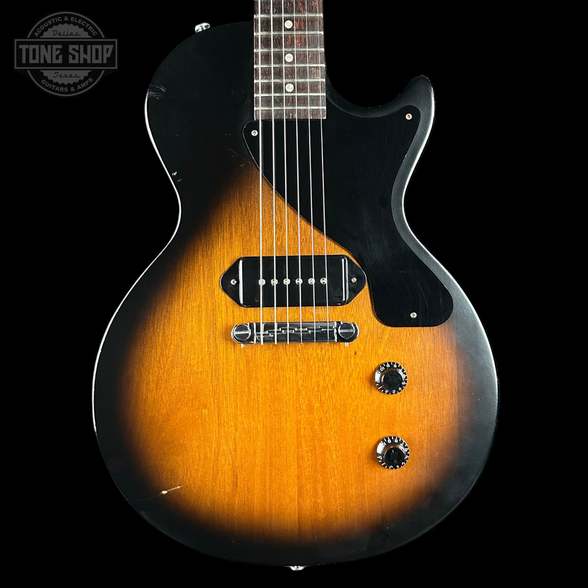 Electric guitar with a sunburst finish on a black background, featuring the Tone Shop logo.