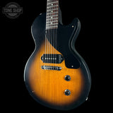 Electric guitar with a sunburst finish on a black background, featuring the Tone Shop logo.