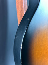 Close-up of a car seat with a visible scratch on the black leather surface.