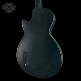 Black electric guitar body with 'Tone Shop' logo in the corner