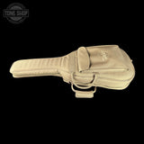 Beige guitar case with Taylor logo on a black background