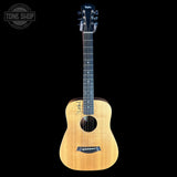 Acoustic guitar with a visible brand logo on a black background