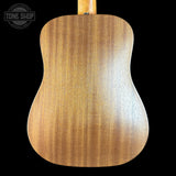 Back view of a wooden acoustic guitar with 'Tone Shop' logo in the corner.