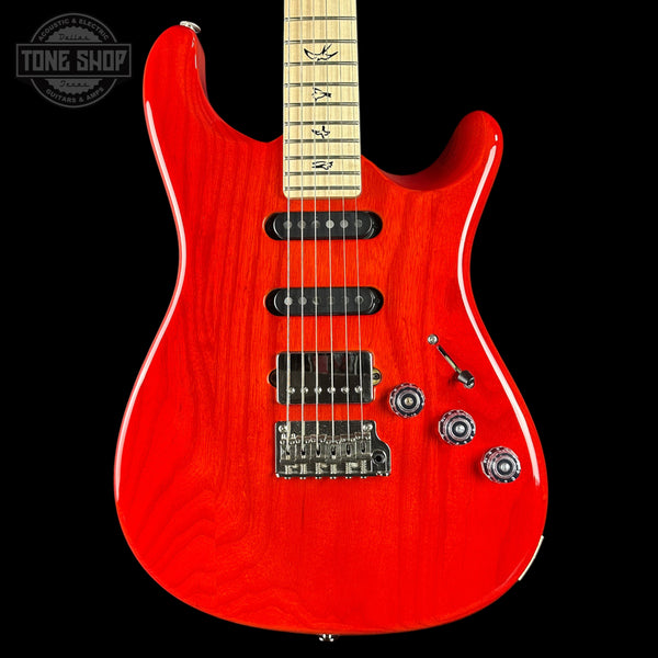 Red electric guitar with a black background
