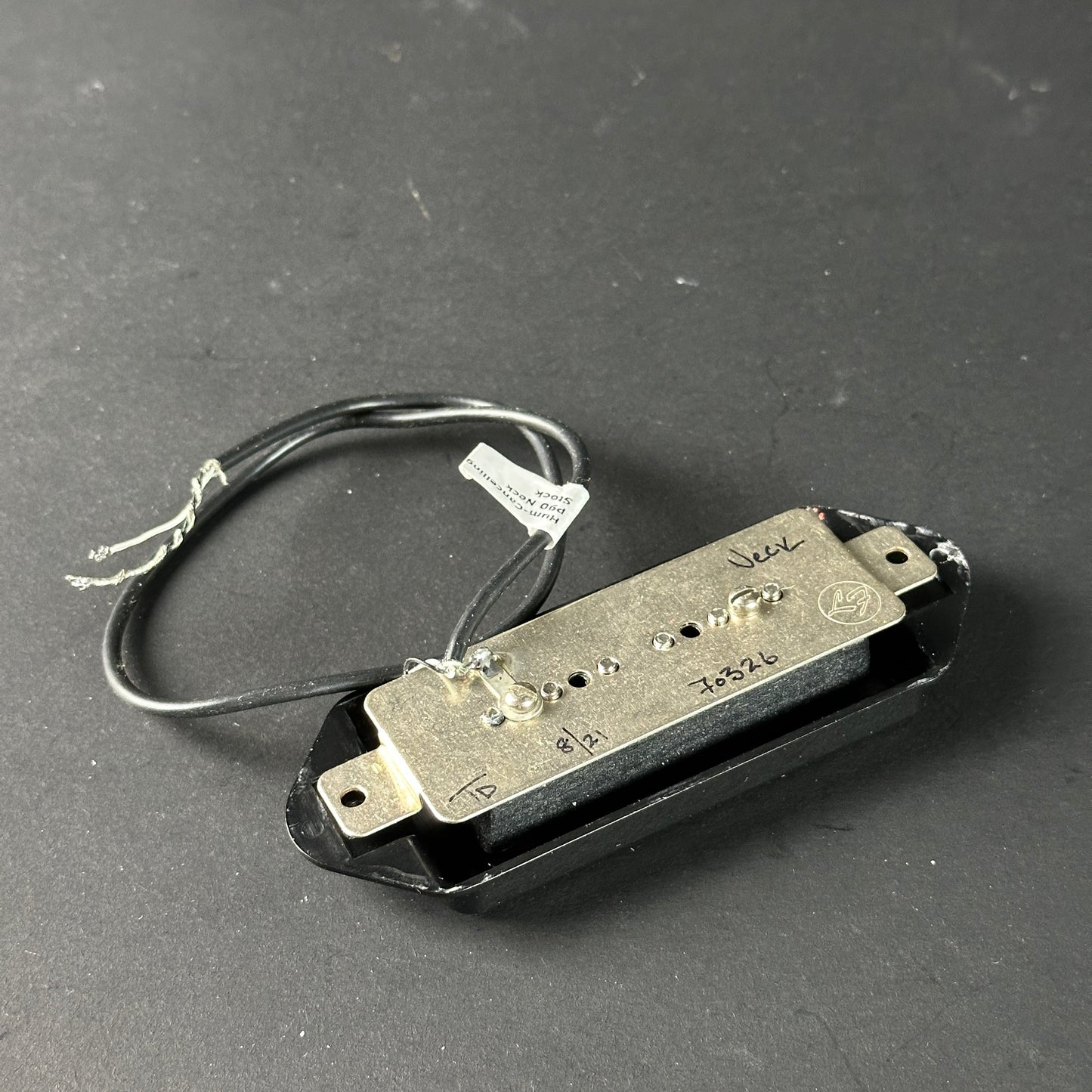 Guitar pickup with visible brand name on a dark gray background