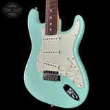 Turquoise electric guitar with a 'Tone Shop' logo in the corner